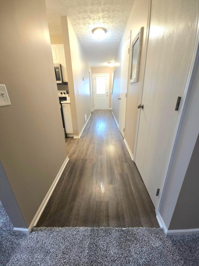 6682 Lagrange Dr Unit 48B, Canal Winchester, OH 43110 - hall with a textured ceiling, baseboards, and wood finished floors