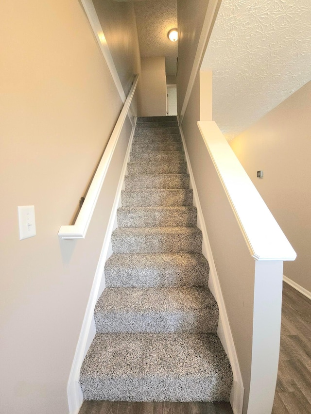 6682 Lagrange Dr Unit 48B, Canal Winchester, OH 43110 - staircase with baseboards, a textured ceiling, and wood finished floors