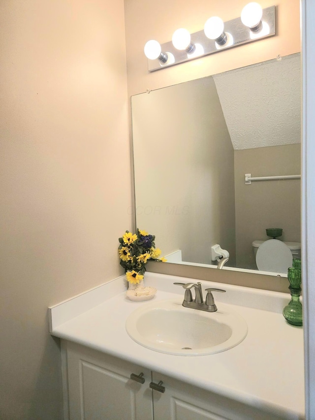 6682 Lagrange Dr Unit 48B, Canal Winchester, OH 43110 - half bathroom featuring vanity, vaulted ceiling, and toilet