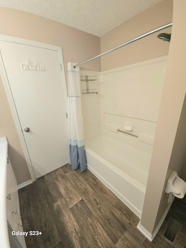 6682 Lagrange Dr Unit 48B, Canal Winchester, OH 43110 - full bathroom with a textured ceiling, wood finished floors, and shower / bath combination with curtain