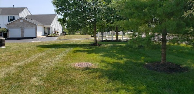 6682 Lagrange Dr Unit 48B, Canal Winchester, OH 43110 - view of yard with fence, an attached garage, and driveway