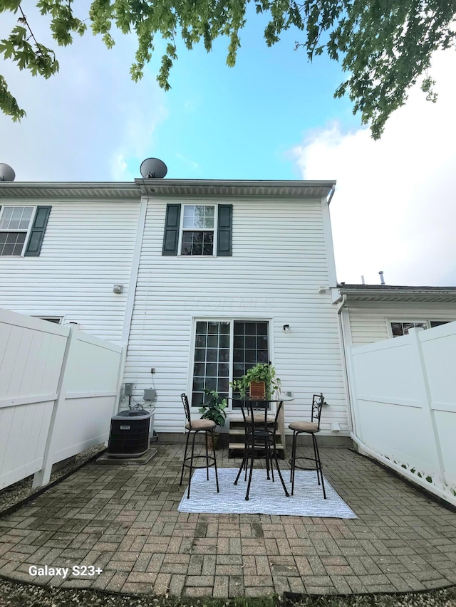 6682 Lagrange Dr Unit 48B, Canal Winchester, OH 43110 - back of house featuring central air condition unit, a fenced backyard, and a patio area
