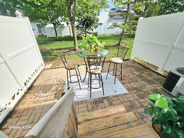 6682 Lagrange Dr Unit 48B, Canal Winchester, OH 43110 - view of patio featuring central AC unit, a fenced backyard, and outdoor dining space