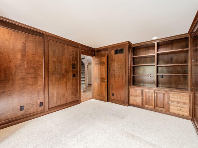 unfurnished bedroom with visible vents and carpet