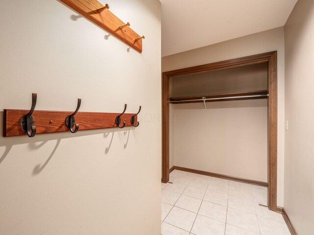 spacious closet with light tile patterned floors