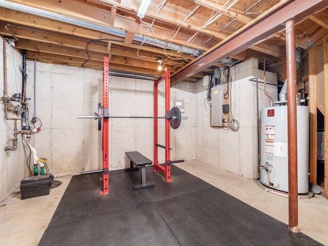 unfinished below grade area featuring water heater and electric panel