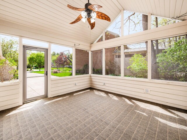 unfurnished sunroom with a ceiling fan