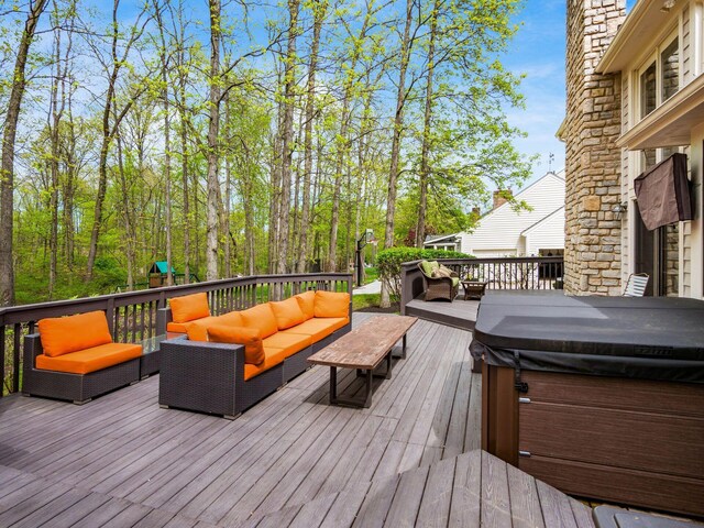 deck featuring a hot tub and an outdoor living space