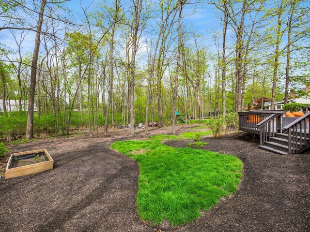 view of yard featuring a vegetable garden and a deck