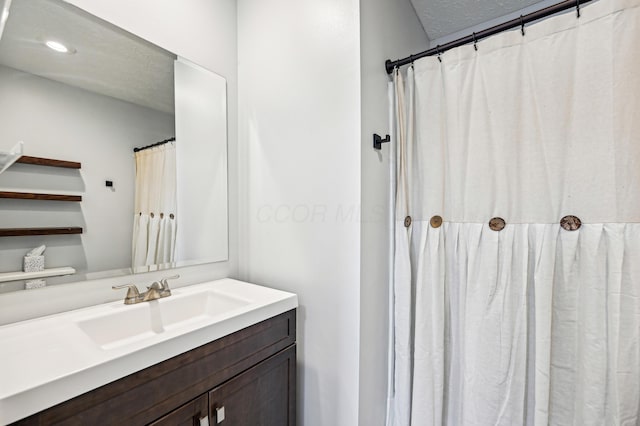 bathroom featuring recessed lighting and vanity