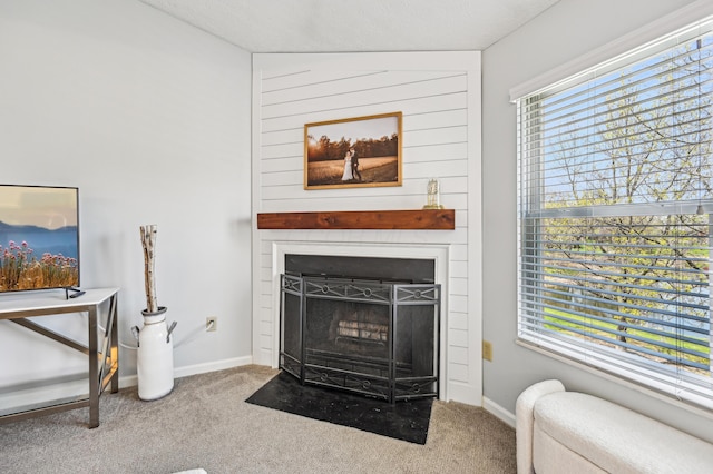 interior details featuring carpet flooring, baseboards, and a fireplace
