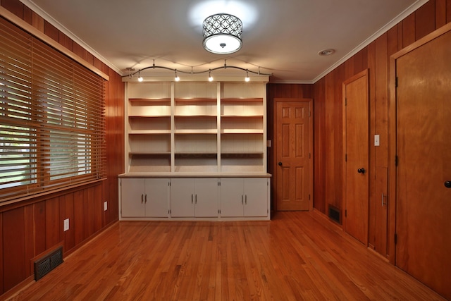 2589 Brookwood Rd, Columbus, OH 43209 - empty room featuring ornamental molding, wood walls, and light wood-style floors