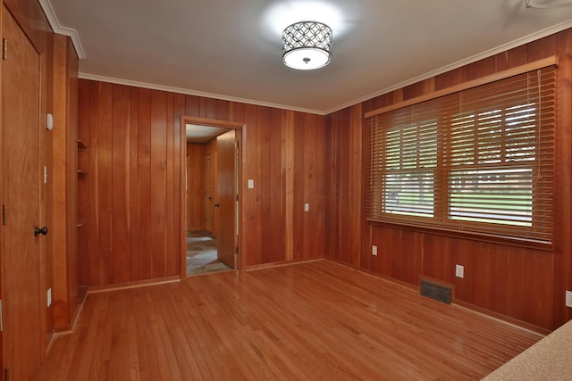 2589 Brookwood Rd, Columbus, OH 43209 - unfurnished room featuring light wood-style floors, crown molding, wooden walls, and baseboards