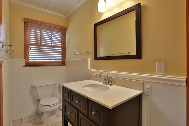 2589 Brookwood Rd, Columbus, OH 43209 - half bathroom featuring a wainscoted wall, vanity, ornamental molding, toilet, and tile patterned flooring