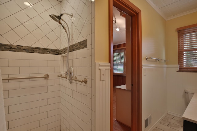 2589 Brookwood Rd, Columbus, OH 43209 - bathroom with ornamental molding, tiled shower, a wainscoted wall, and plenty of natural light
