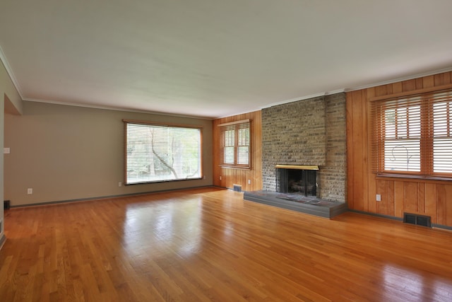 2589 Brookwood Rd, Columbus, OH 43209 - unfurnished living room featuring healthy amount of natural light, wood finished floors, a fireplace, ornamental molding, and baseboards