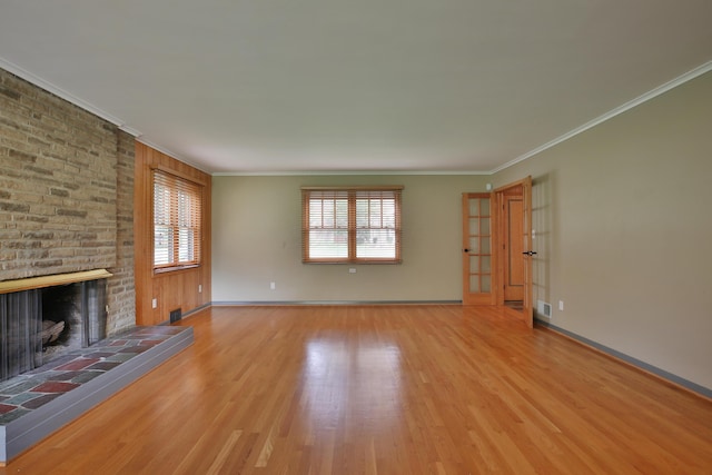 2589 Brookwood Rd, Columbus, OH 43209 - unfurnished living room featuring wood finished floors, ornamental molding, a brick fireplace, and baseboards