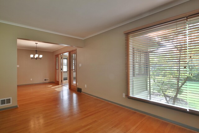 2589 Brookwood Rd, Columbus, OH 43209 - unfurnished room with a chandelier, light wood-style flooring, ornamental molding, and baseboards