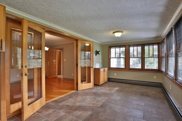 2589 Brookwood Rd, Columbus, OH 43209 - empty room with ornamental molding, french doors, baseboards, and a baseboard heating unit