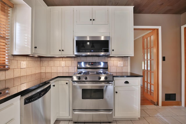 2589 Brookwood Rd, Columbus, OH 43209 - kitchen with stainless steel appliances, dark countertops, decorative backsplash, white cabinets, and wood ceiling