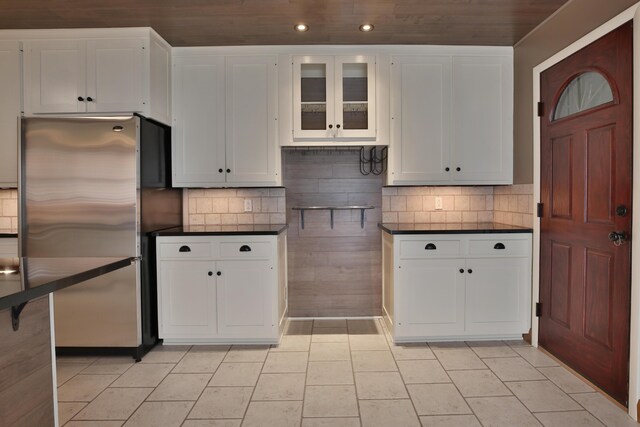 2589 Brookwood Rd, Columbus, OH 43209 - kitchen with freestanding refrigerator, dark countertops, white cabinetry, recessed lighting, and glass insert cabinets
