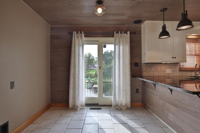 2589 Brookwood Rd, Columbus, OH 43209 - entryway with plenty of natural light, baseboards, a sink, wood ceiling, and light tile patterned floors
