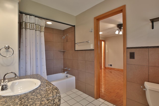 2589 Brookwood Rd, Columbus, OH 43209 - bathroom featuring a sink, a ceiling fan, toilet, tile walls, and shower / tub combo with curtain
