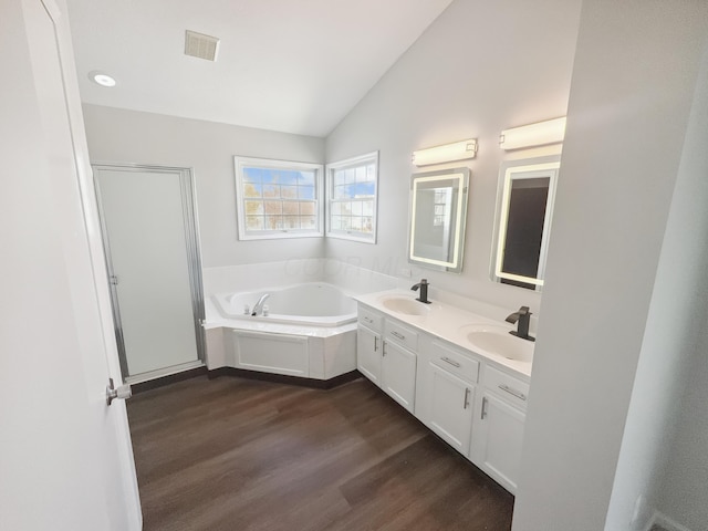 full bathroom with lofted ceiling, wood finished floors, visible vents, and a sink