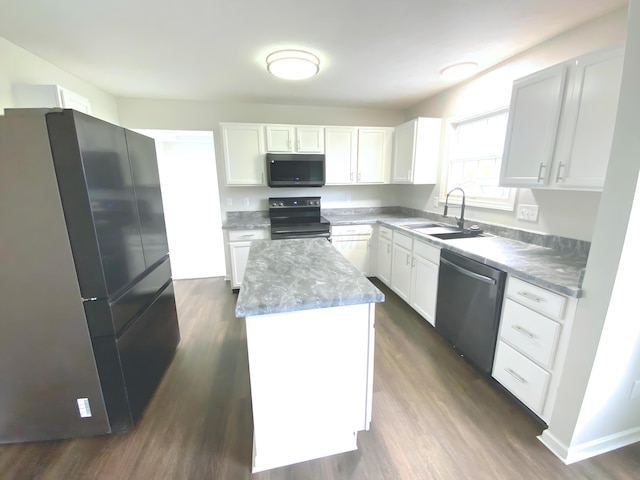 kitchen featuring stainless steel appliances, a kitchen island, white cabinets, and a sink