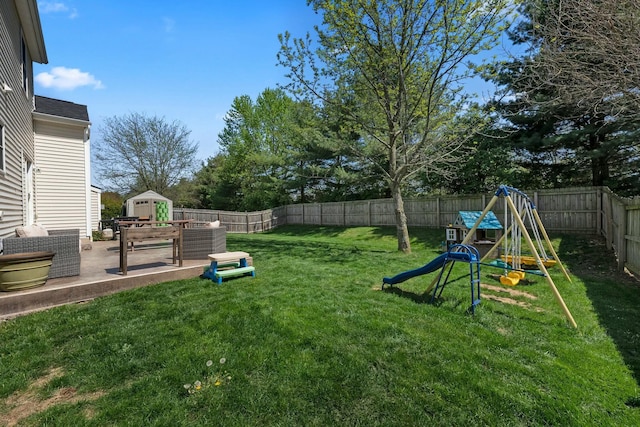 view of yard with a patio, a fenced backyard, and a playground