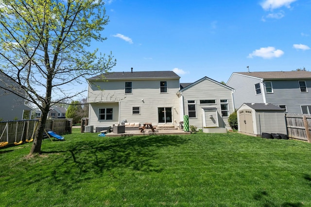 back of property featuring an outdoor living space, a lawn, cooling unit, a fenced backyard, and a storage unit