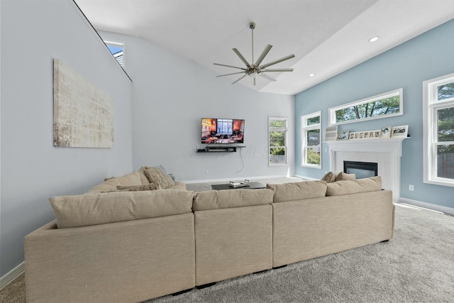 carpeted living area featuring baseboards, ceiling fan, recessed lighting, and a tile fireplace