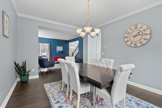 dining space featuring an inviting chandelier, stairway, and wood finished floors