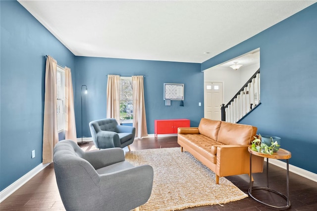 living room with baseboards, stairs, and wood finished floors