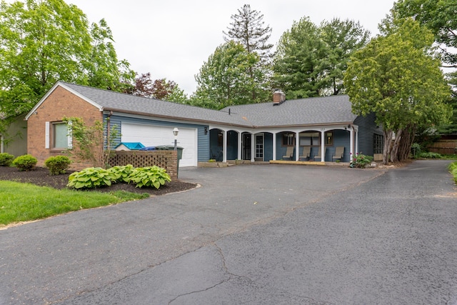 173 S Chesterfield Rd, Columbus, OH 43209 - ranch-style home featuring an attached garage, a chimney, driveway, a shingled roof, and a porch