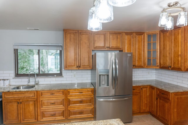 173 S Chesterfield Rd, Columbus, OH 43209 - kitchen featuring stainless steel refrigerator with ice dispenser, a sink, brown cabinetry, and light stone countertops
