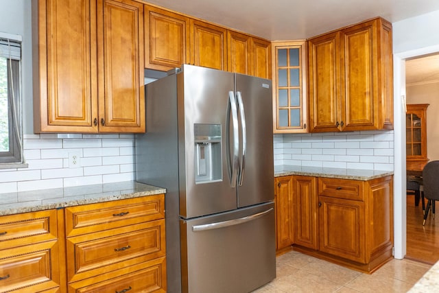 173 S Chesterfield Rd, Columbus, OH 43209 - kitchen with stainless steel refrigerator with ice dispenser, brown cabinetry, and light stone countertops