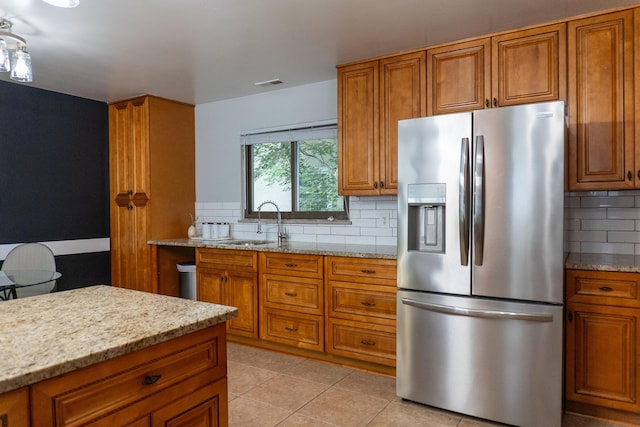 173 S Chesterfield Rd, Columbus, OH 43209 - kitchen with stainless steel fridge with ice dispenser, brown cabinets, a sink, and decorative backsplash