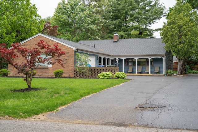173 S Chesterfield Rd, Columbus, OH 43209 - ranch-style home with a chimney, a porch, a front lawn, brick siding, and asphalt driveway