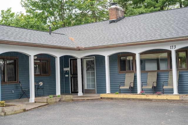 173 S Chesterfield Rd, Columbus, OH 43209 - entrance to property with a shingled roof, a chimney, and a porch