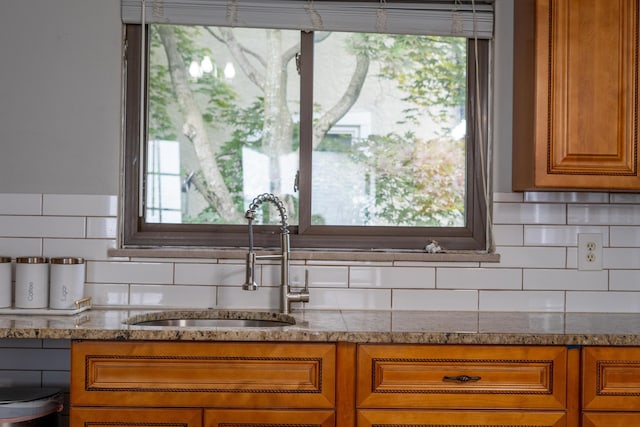 173 S Chesterfield Rd, Columbus, OH 43209 - kitchen featuring a sink, brown cabinetry, and decorative backsplash