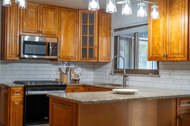 173 S Chesterfield Rd, Columbus, OH 43209 - kitchen with stainless steel appliances, a sink, brown cabinets, and light stone counters