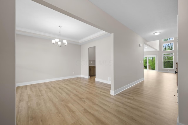 1206 Clover St, Sunbury, OH 43074 - spare room featuring crown molding, baseboards, a notable chandelier, and light wood-type flooring