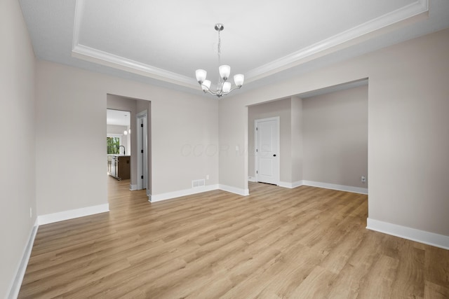 1206 Clover St, Sunbury, OH 43074 - empty room featuring an inviting chandelier, ornamental molding, a tray ceiling, and visible vents