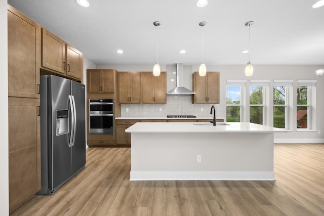 1206 Clover St, Sunbury, OH 43074 - kitchen with a sink, light countertops, light wood-style flooring, wall chimney exhaust hood, and stainless steel appliances
