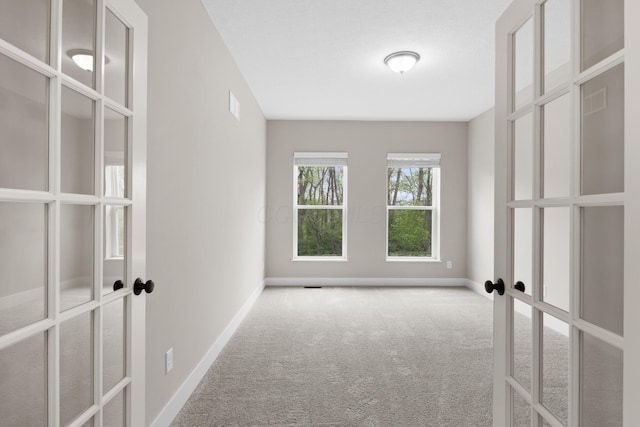 1206 Clover St, Sunbury, OH 43074 - carpeted spare room featuring baseboards and french doors