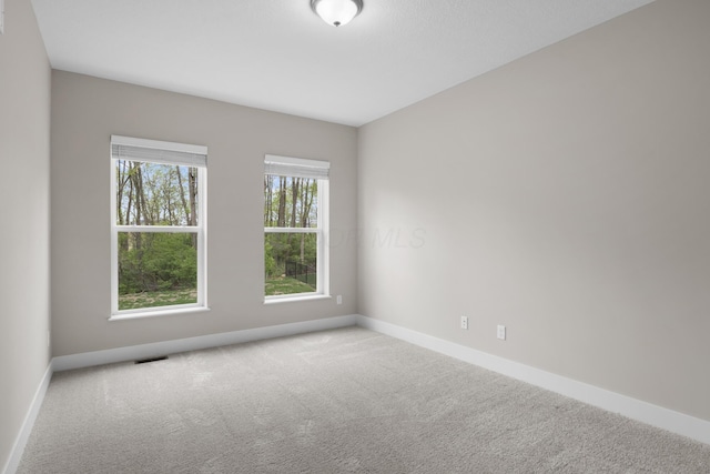 1206 Clover St, Sunbury, OH 43074 - spare room featuring carpet floors, baseboards, and visible vents