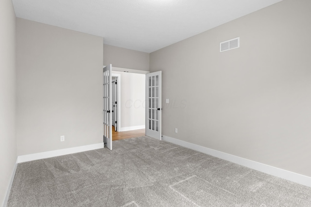 1206 Clover St, Sunbury, OH 43074 - unfurnished room with visible vents, carpet, baseboards, and french doors