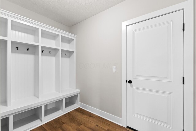 1206 Clover St, Sunbury, OH 43074 - mudroom featuring baseboards, dark wood finished floors, and a textured ceiling