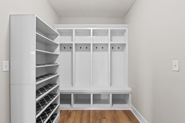 1206 Clover St, Sunbury, OH 43074 - mudroom with baseboards, a textured ceiling, and wood finished floors